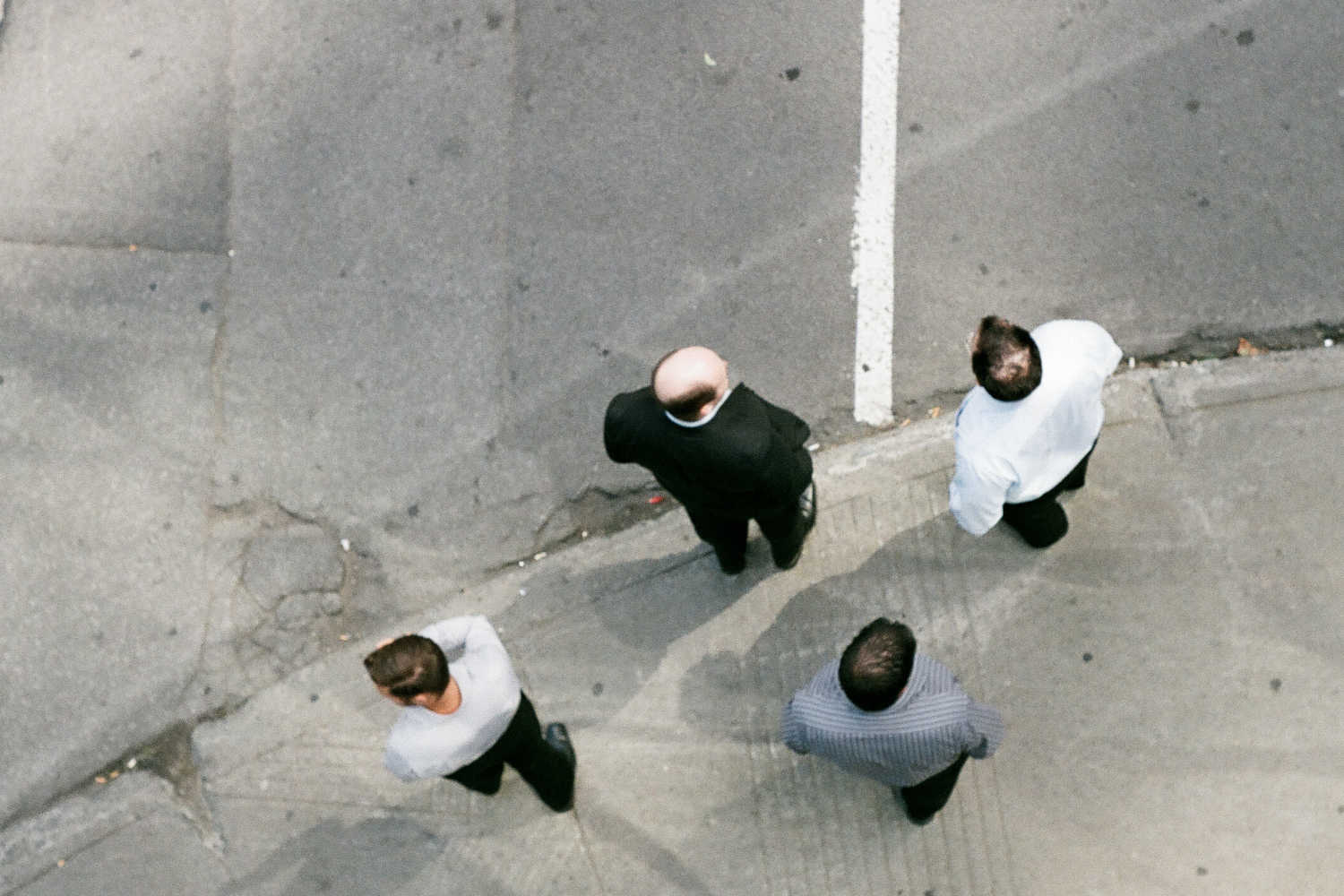 Four pedestrians waiting for a green light