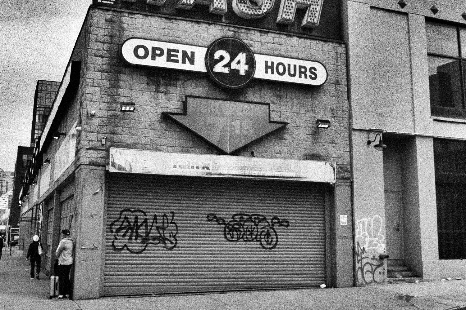 Picture of a closed car wash with an "Open 24 hours" sign